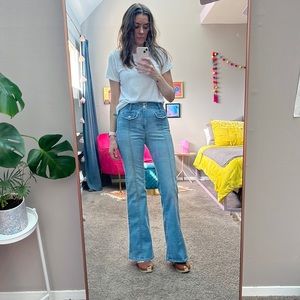 Bebe high waist flared jeans with decorative pockets. Size 27